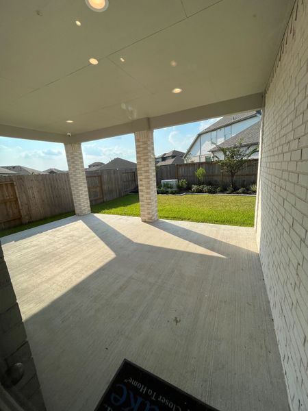 A covered patio with brick pillars overlooks a private fenced yard, perfect for outdoor gatherings. A covered patio with brick pillars overlooks a private fenced yard, perfect for outdoor gatherings.