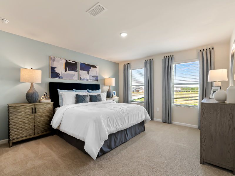 The large primary suite features an ensuite bath with dual sinks and a spacious walk-in closet.