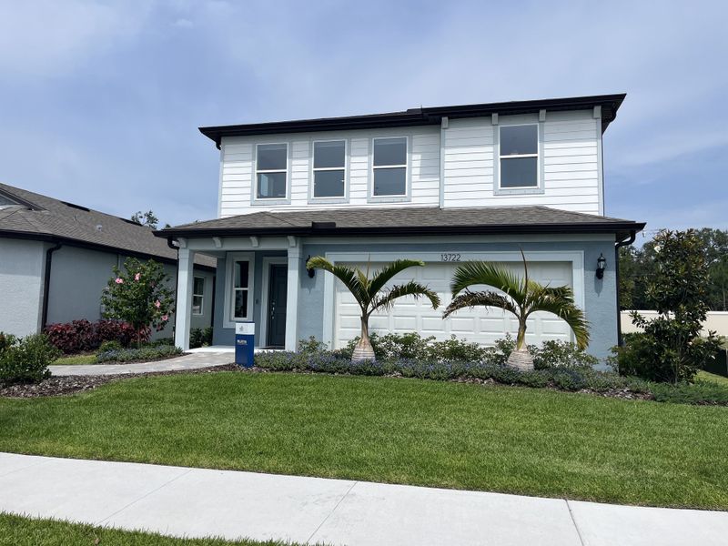 A modern two-story home with a manicured lawn in Spencer Glen by Pulte Homes (Riverview, FL). A modern two-story home with a manicured lawn in Spencer Glen by Pulte Homes (Riverview, FL).
