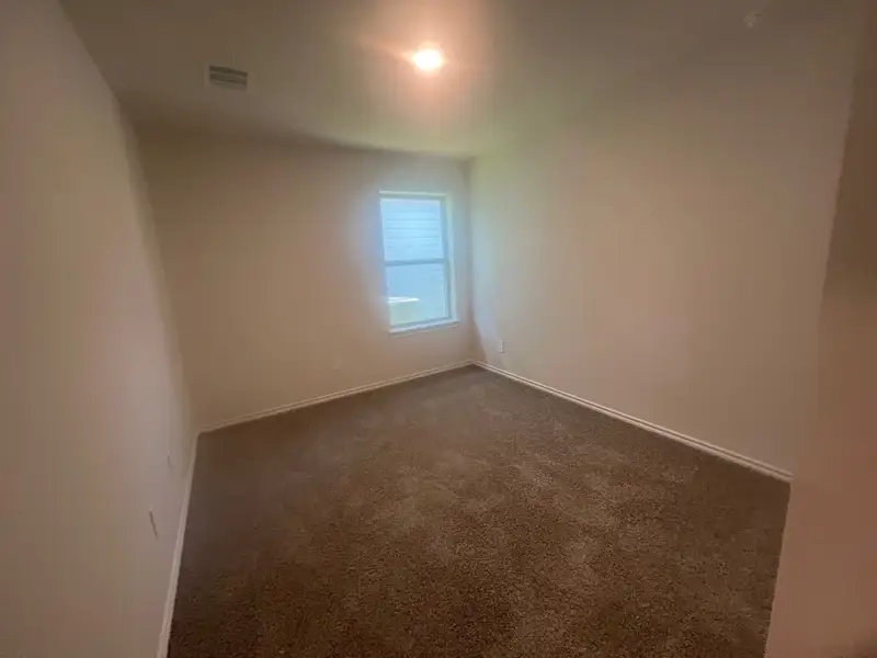 A cozy room with neutral walls, plush carpet, and a bright window, perfect for personalization and comfort. A cozy room with neutral walls, plush carpet, and a bright window, perfect for personalization and comfort.