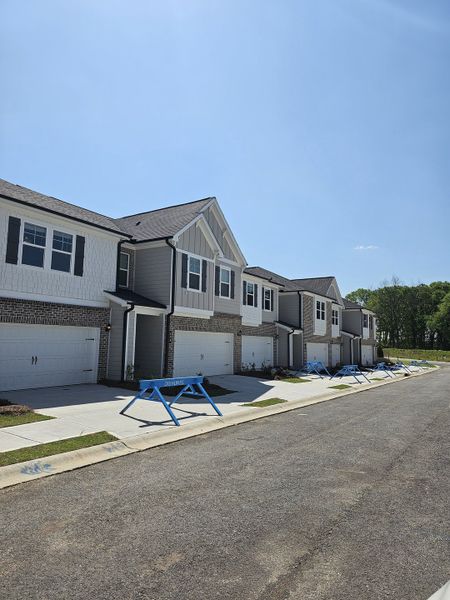 Stylish townhomes with modern exteriors and landscaped driveways in Diamante by DRB Homes (Stockbridge, GA). Stylish townhomes with modern exteriors and landscaped driveways in Diamante by DRB Homes (Stockbridge, GA).
