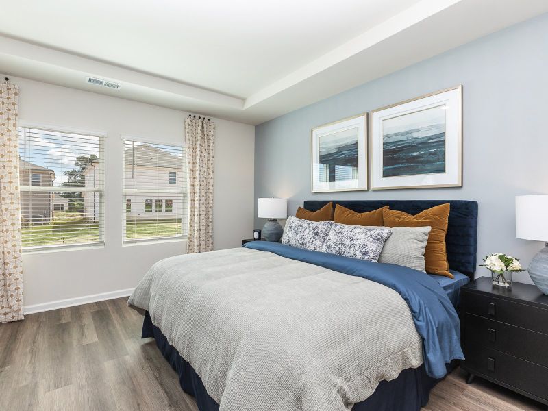 The luxurious primary suite features tray ceilings.