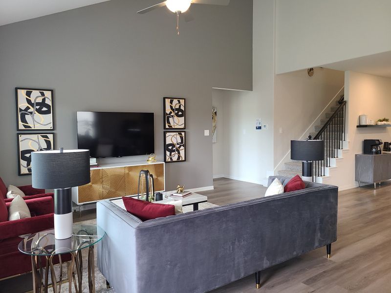A modern living room featuring stylish gray walls, a sleek entertainment setup, and cozy seating with elegant decor. A modern living room featuring stylish gray walls, a sleek entertainment setup, and cozy seating with elegant decor.