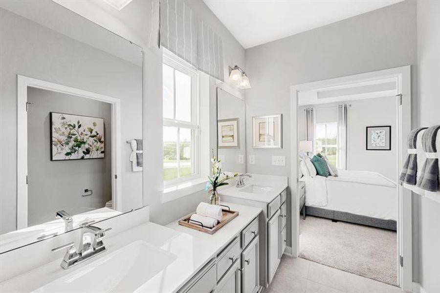 A bright, naturally lit owner’s bath with thoughtful space to recharge. A bright, naturally lit owner’s bath with thoughtful space to recharge.