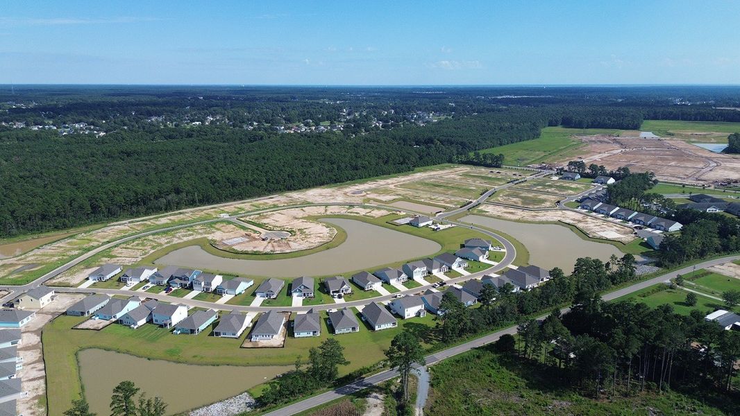 Aerial view of the Rich Square at Brunswick Plantation community in Ash, NC, showing layout and nearby surroundings (Image 13). Aerial view of the Rich Square at Brunswick Plantation community in Ash, NC, showing layout and nearby surroundings (Image 13).