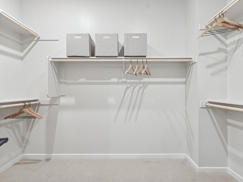 A white bathtub with a shelf and a mirror.