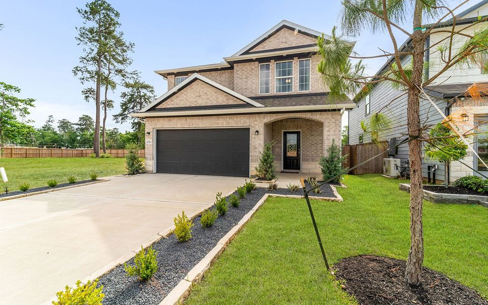 Front exterior of a home in the The Pines at Seven Coves community, located in Willis, TX (Image 9).