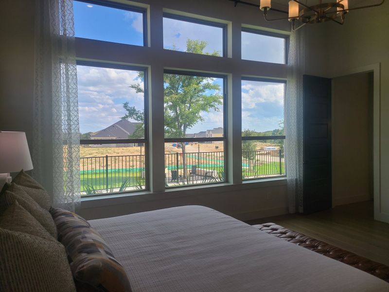 A cozy bedroom with large windows, elegant drapes, and ample natural light creating a serene atmosphere. A cozy bedroom with large windows, elegant drapes, and ample natural light creating a serene atmosphere.