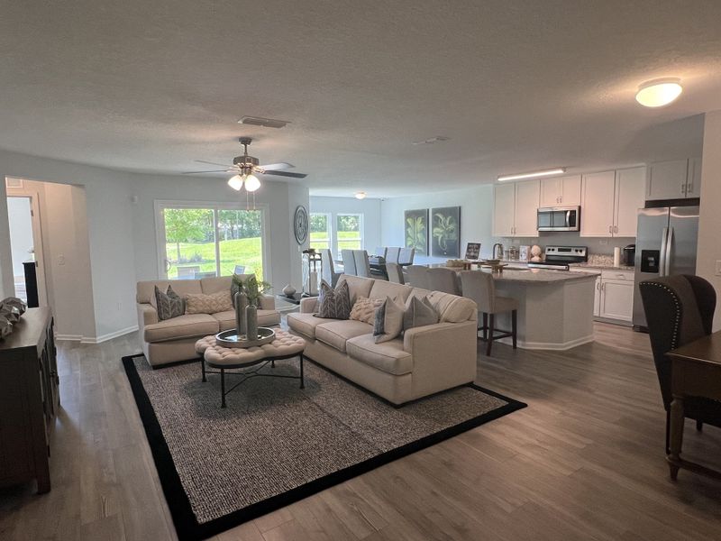 An open-plan living area with cozy seating, elegant dining, and a modern kitchen with stainless appliances. An open-plan living area with cozy seating, elegant dining, and a modern kitchen with stainless appliances.