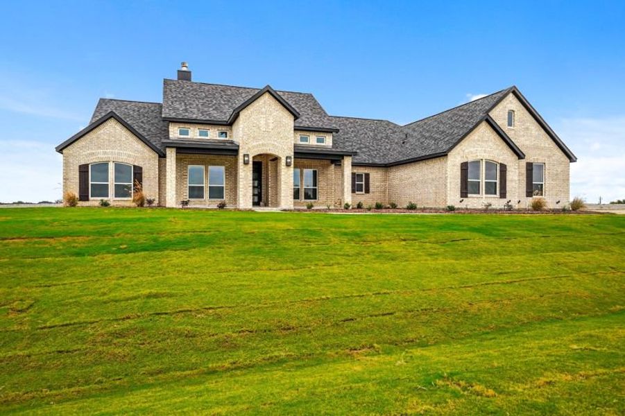 Front exterior of a home in the Rocky Top Ranch community, located in Reno, TX (Image 1).