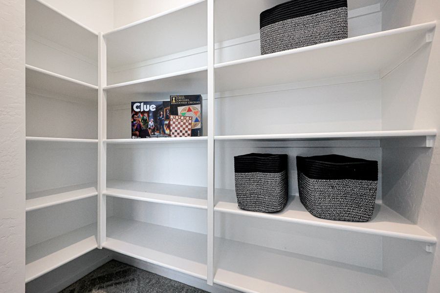 A white shelving unit with baskets and baskets. A white shelving unit with baskets and baskets.