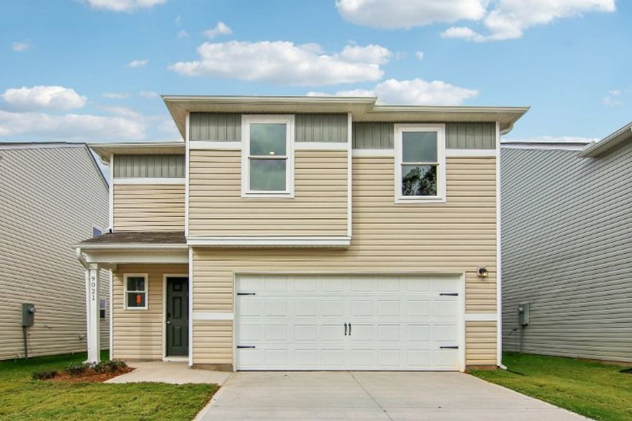 A house with garages and a driveway.