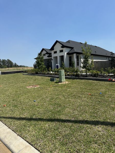 A modern home with black roofing and manicured landscaping in Montgomery Bend by Pulte Homes (Montgomery, TX). A modern home with black roofing and manicured landscaping in Montgomery Bend by Pulte Homes (Montgomery, TX).