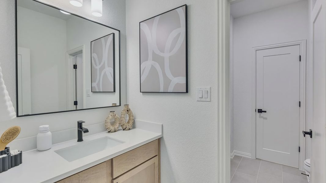 Sleek wood cabinetry and elegant contemporary fixtures enhance this Briarwood bathroom.