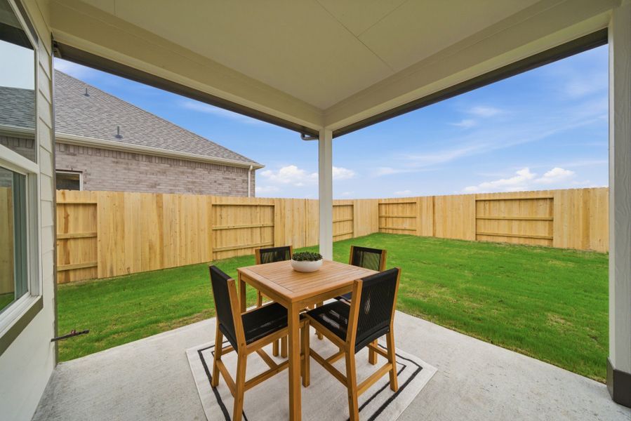 A table and chairs on a patio. A table and chairs on a patio.