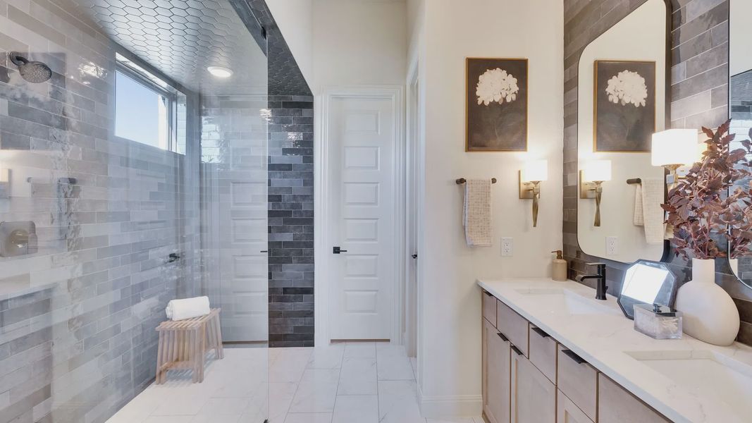 Experience sophistication in Flora with marble surfaces, seamless glass shower, and stylish tilework enhancing luxury living.