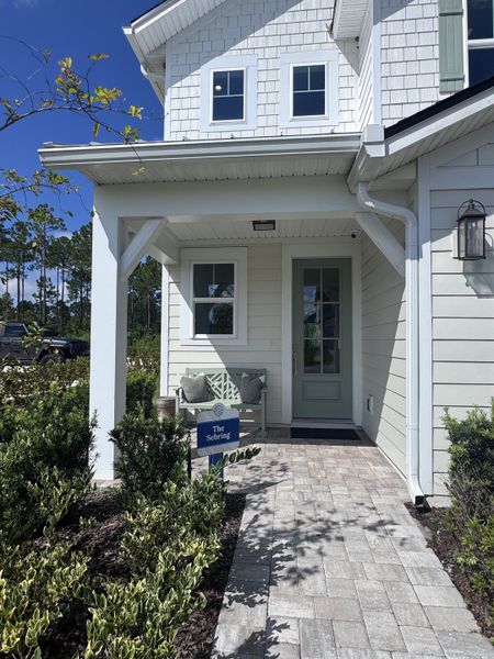 Charming white home with a welcoming porch in Crosswinds at Nocatee by Riverside Homes (Ponte Vedra Beach, FL).