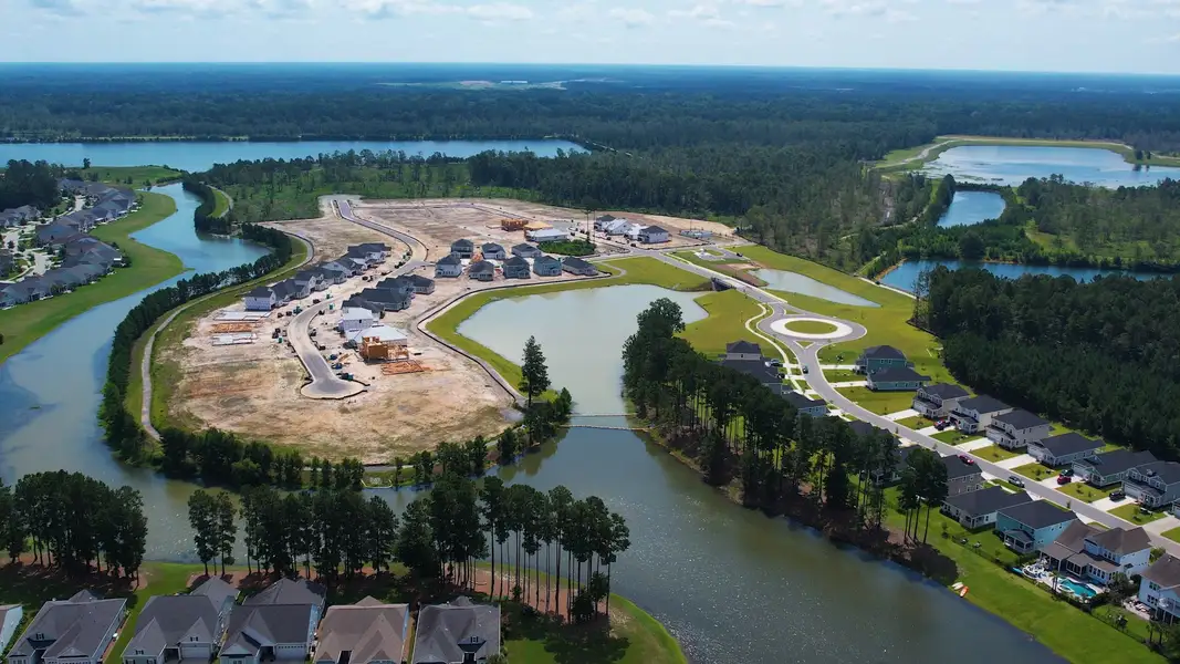 Aerial view of the The Coves at Lakes of Cane Bay community in Summerville, SC, showing layout and nearby surroundings (Image 1). Aerial view of the The Coves at Lakes of Cane Bay community in Summerville, SC, showing layout and nearby surroundings (Image 1).