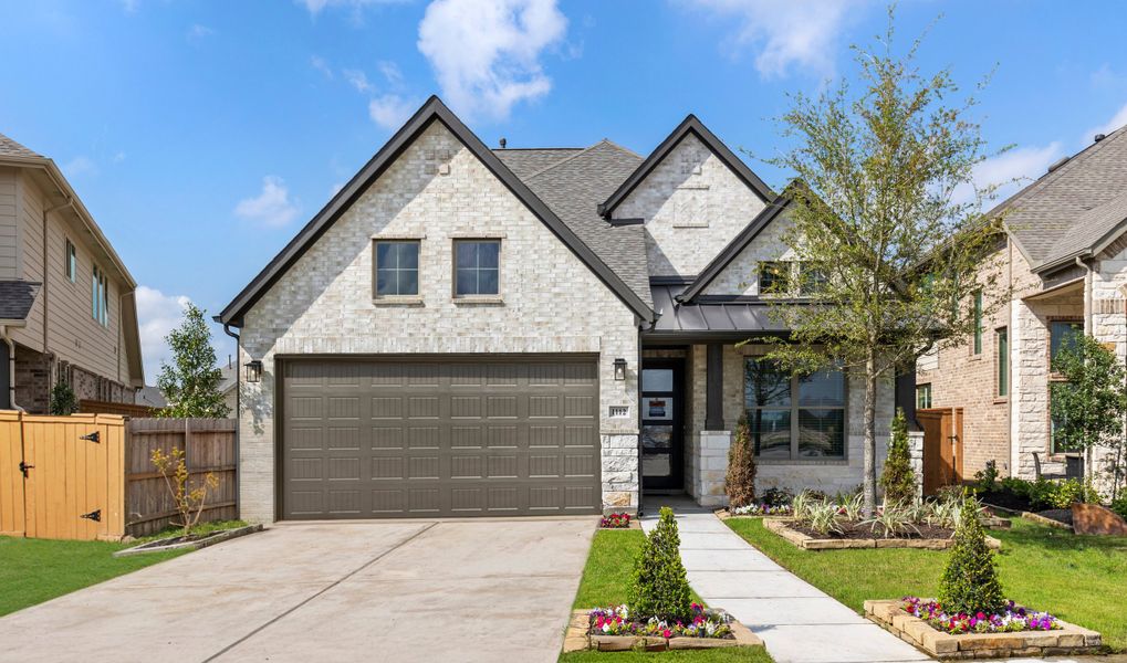 Front exterior of a home in the Sunterra community, located in Katy, TX (Image 16).