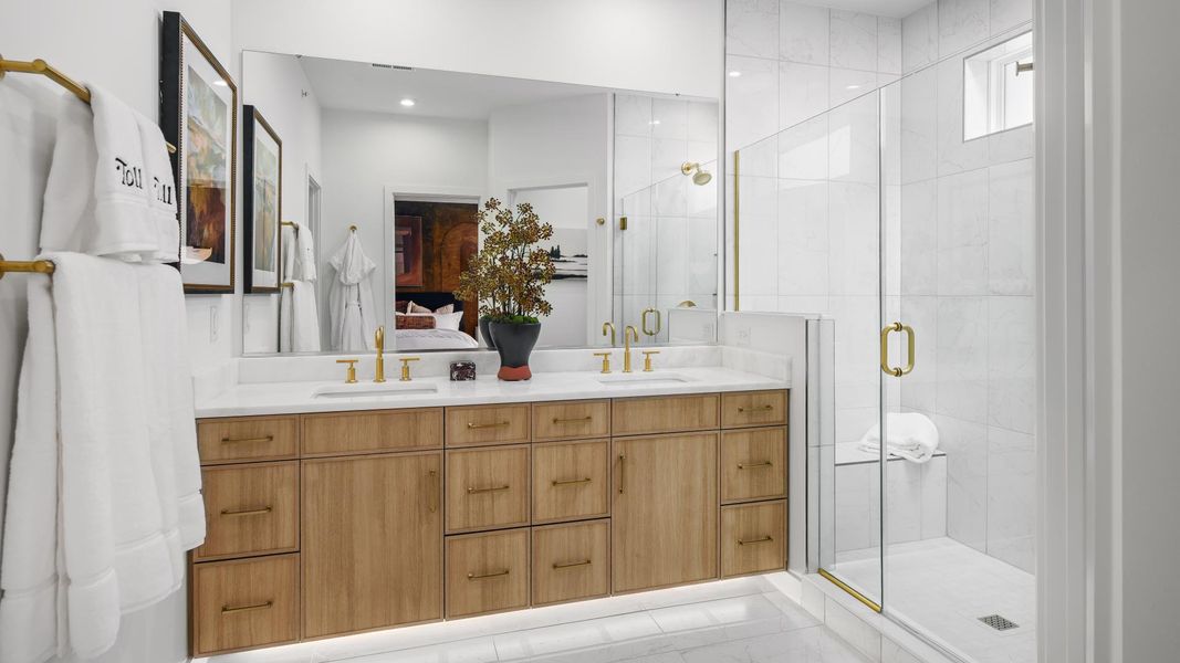 Lavish primary bath with a dual sink vanity and large shower