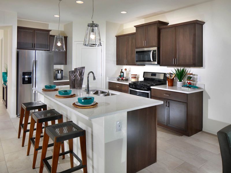 The kitchen boasts a large kitchen island with room for seating and a generous pantry.