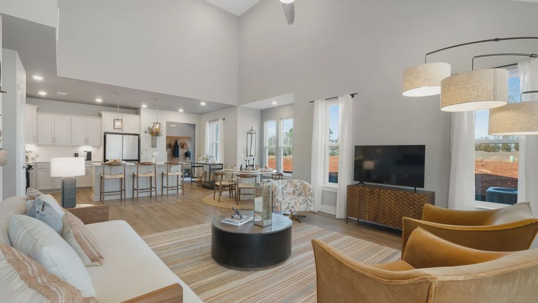 Spacious, open concept living spaces with hardwood flooring and two story ceilings at Barton Hollow by DRB Homes