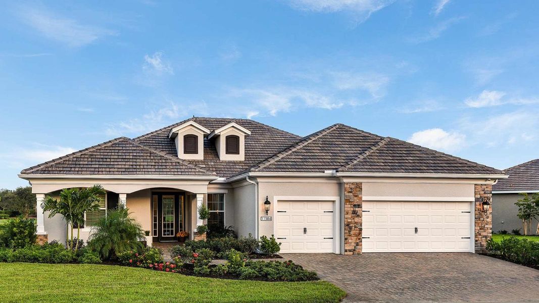 Front exterior of a home in the Verandah Real Estate and Homes for Sale in Fort Myers, FL - Neal Communities community, located in Fort Myers, FL (Image 4).