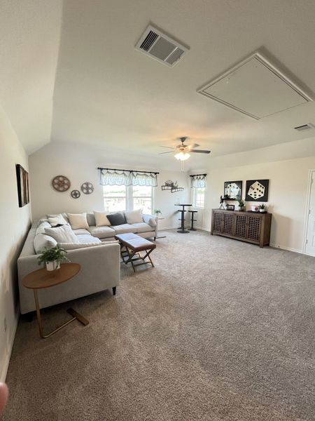 A cozy living room with a plush carpet, inviting sectional, and decorative accents, bathed in natural light. A cozy living room with a plush carpet, inviting sectional, and decorative accents, bathed in natural light.