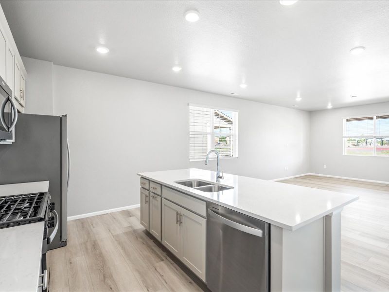 Kitchen in the Woodland floorplan at a Meritage Homes community in Broomfield, CO.