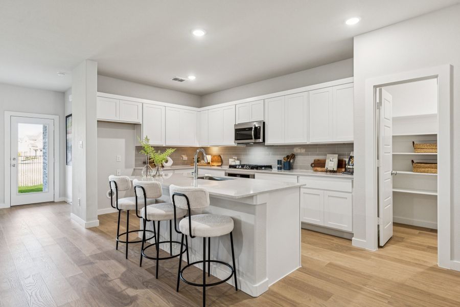 REPRESENTATIVE PHOTO – Kitchen  in the Oscar model home in Aledo TX by Trophy Signature Homes