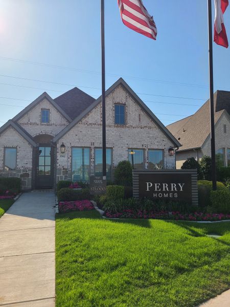 Charming brick home with manicured lawn and flags in Prairie Oaks 40' by Perry Homes (Little Elm, TX). Charming brick home with manicured lawn and flags in Prairie Oaks 40' by Perry Homes (Little Elm, TX).