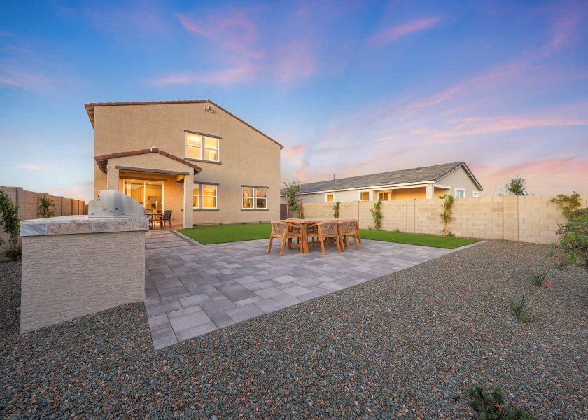 A house with a patio and chairs. A house with a patio and chairs.