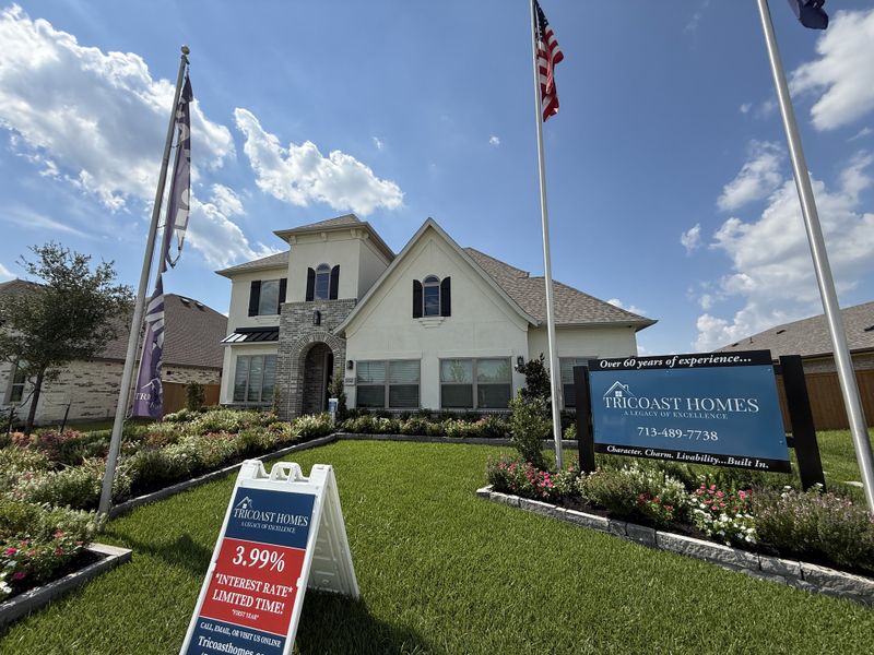 A beautiful two-story home with lush landscaping in Canterra Creek 60' by Tricoast Homes (Rosharon, TX).