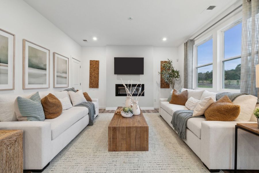 A living room with a large window. A living room with a large window.