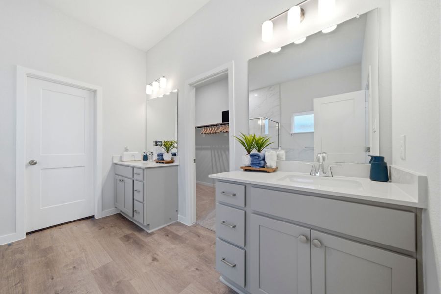 A bathroom with white cabinets. A bathroom with white cabinets.