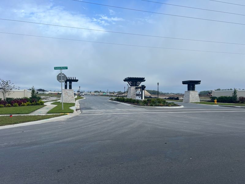 An elegant entryway to Ashton Covey by Ryan Homes with landscaped details in Winter Haven, FL.