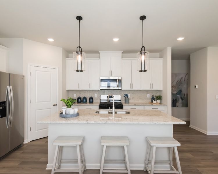 A large kitchen island doubles as your new favorite hangout spot.