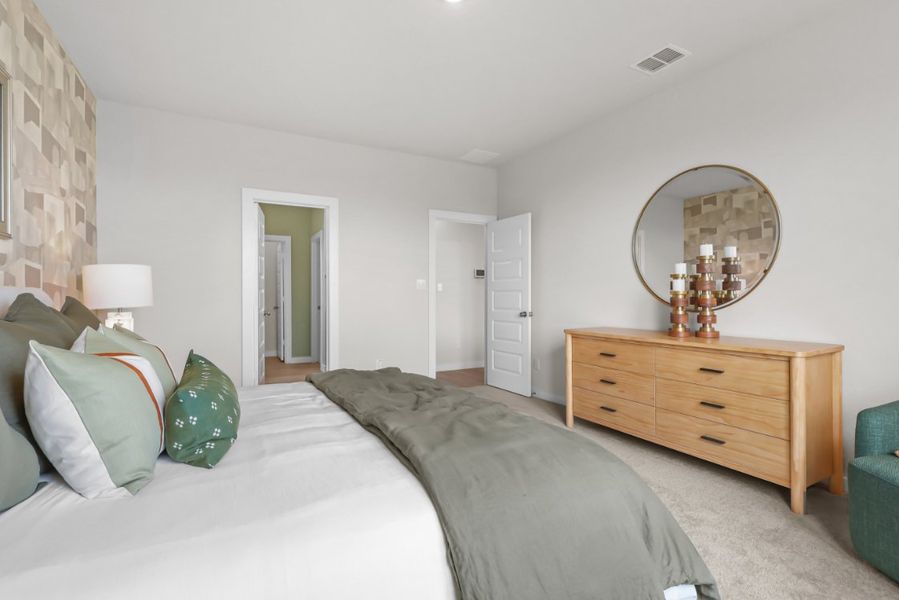 A bedroom with a bed and a mirror. A bedroom with a bed and a mirror.