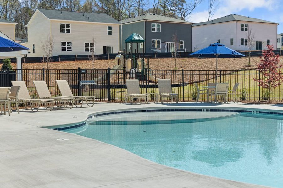 A pool with chairs around it. A pool with chairs around it.