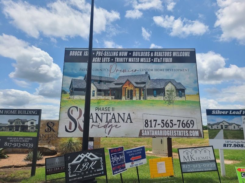 Scenic billboard for Santana Ridge by MK Homes in Weatherford, TX, showcasing a custom home development in a lush setting.