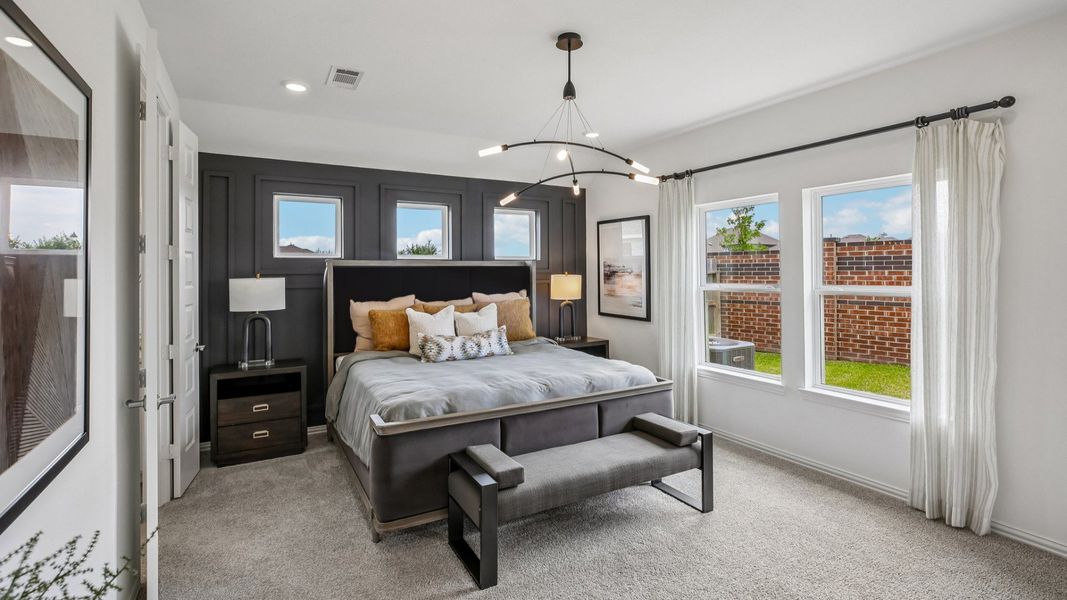 Elegant bedroom with modern lighting fixtures and plush textiles in Cypress Green community. Elegant bedroom with modern lighting fixtures and plush textiles in Cypress Green community.
