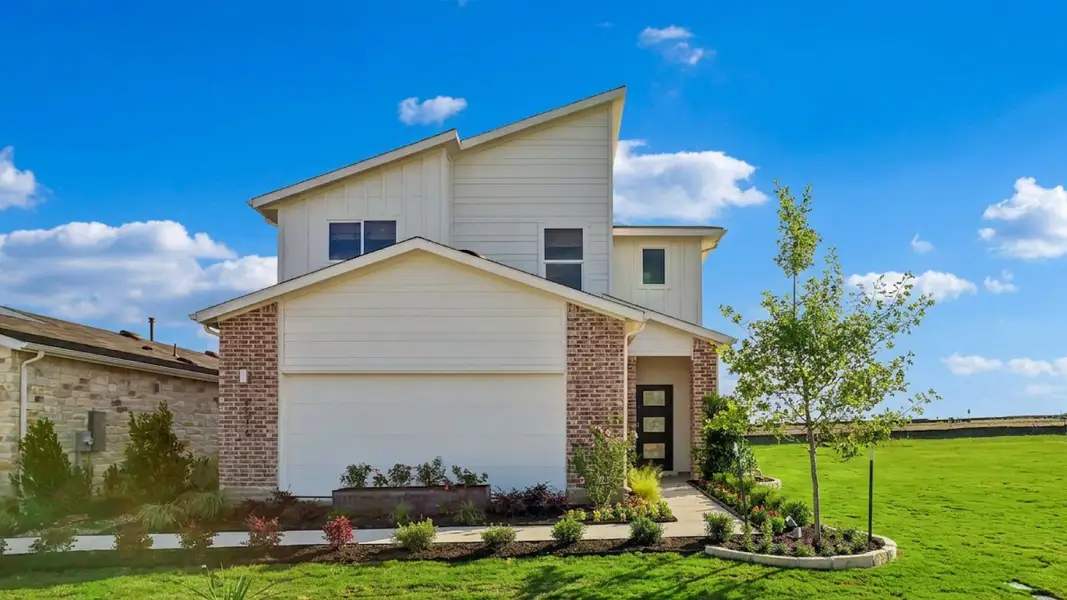 Front exterior of a home in the Frontier community, located in Mustang Ridge, TX (Image 2).