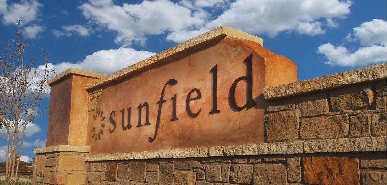Entrance to the Sunfield community in Buda, TX, featuring signage and landscaping (Image 2). Entrance to the Sunfield community in Buda, TX, featuring signage and landscaping (Image 2).
