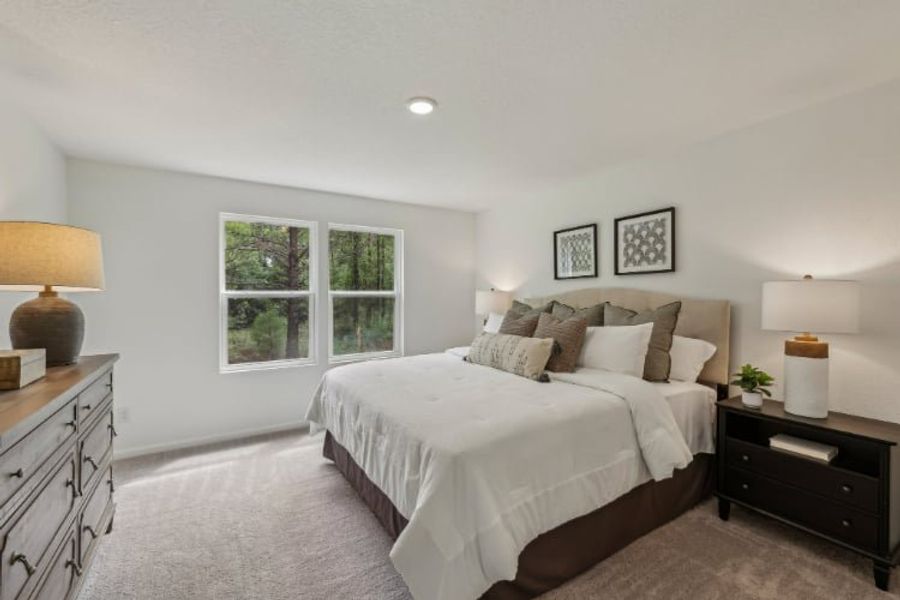 A bedroom with a bed and lamps. A bedroom with a bed and lamps.