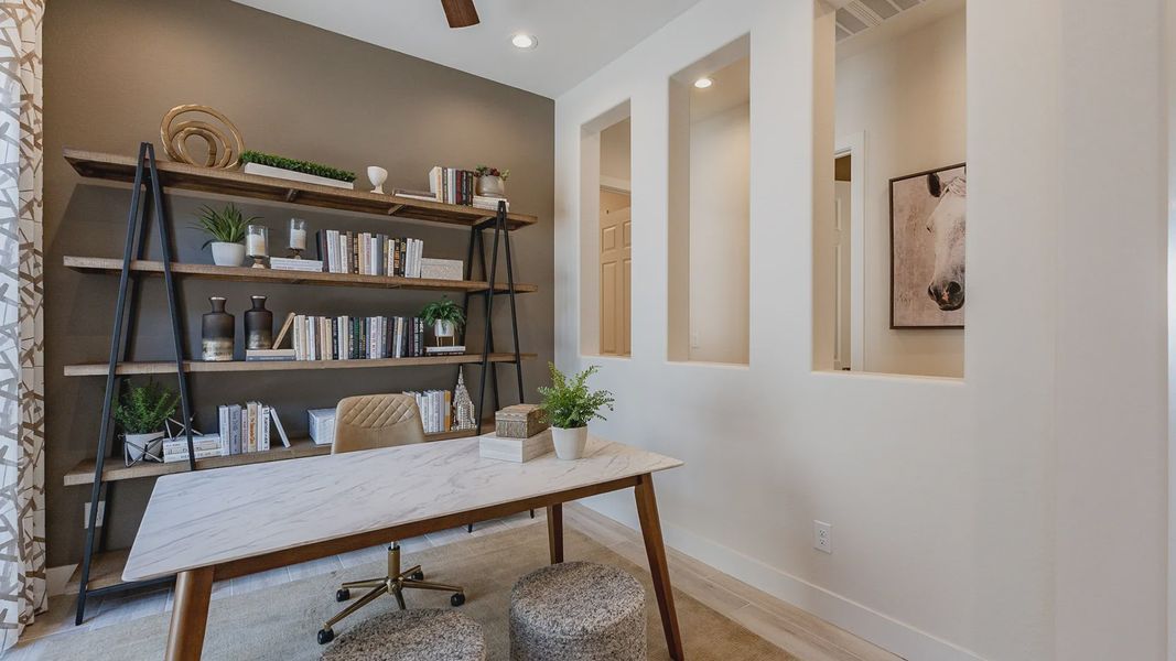 Featuring a sleek marble desk and striking open shelving, this Windrose office embodies modern luxury.