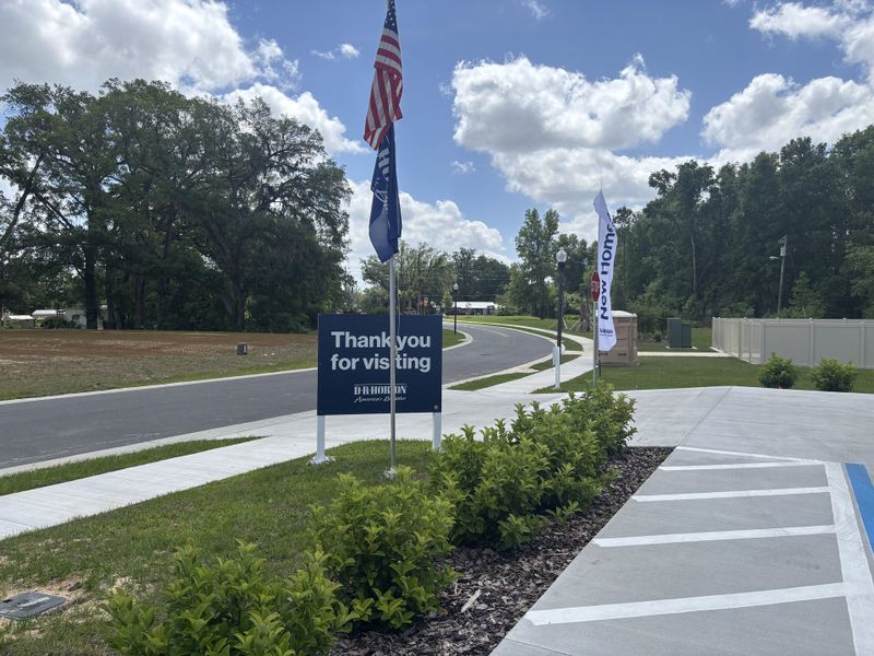 A welcoming entrance with landscaped paths and inviting signage in Autumn Glen by D.R. Horton (Belleview, FL).