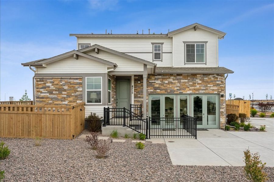 A house with a fence and a gate. A house with a fence and a gate.