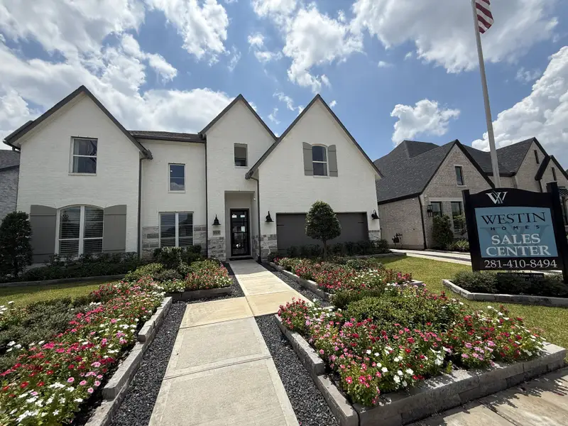 Charming white brick home with manicured flower beds in Sienna - 60' by Westin Homes, Missouri City, TX. Charming white brick home with manicured flower beds in Sienna - 60' by Westin Homes, Missouri City, TX.