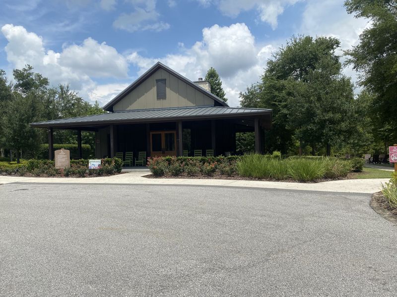 A charming clubhouse with a spacious porch and lush landscaping in Shearwater: Shearwater - Single Family by Lennar (St. Augustine, FL).
