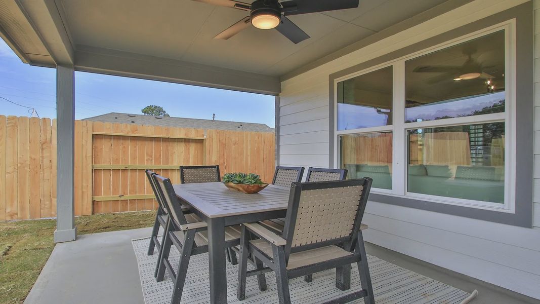 Elegant covered patio features a modern ceiling fan and stylish dining set in Pinehurst.
